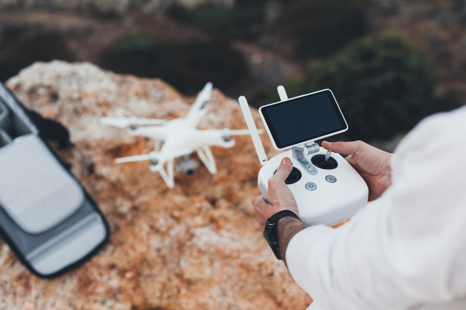 cover stock aerial video creator and photographer prepares drone for flight